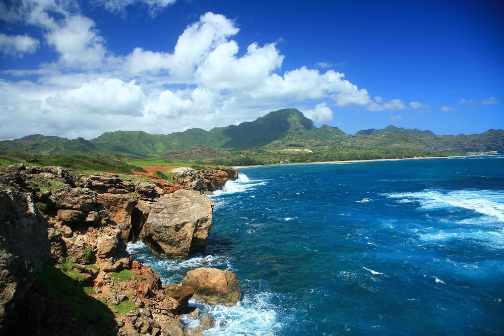 Aerial views of Hawaii Island’s scenic coastline with lava cliffs, blue ocean, and rugged shoreline