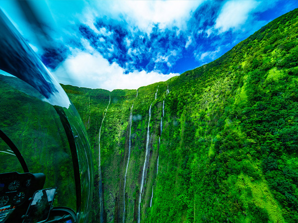 Waimanu Falls on the Big Island, tall waterfall cascading into a secluded valley