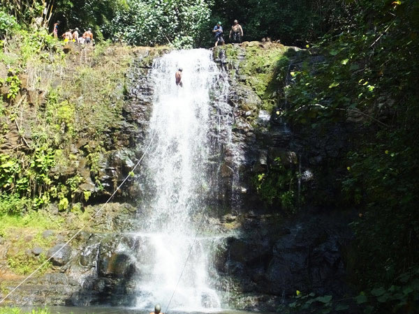 rappelling down waterfall