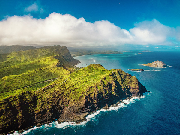 Oahu views from the sky showcasing mountains, valleys, and coastline from a helicopter perspective