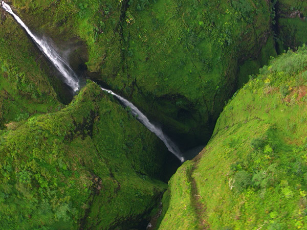 Scenic Oahu waterfalls viewed from above showcasing lush rainforest valleys and cascading falls