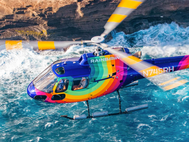 Royal Crown of Oahu helicopter tour featuring rainforest cliffs, waterfalls, and coastal scenery